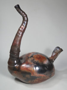 "Swan Song" is a pit-fired porcelain piece by Luke Metz