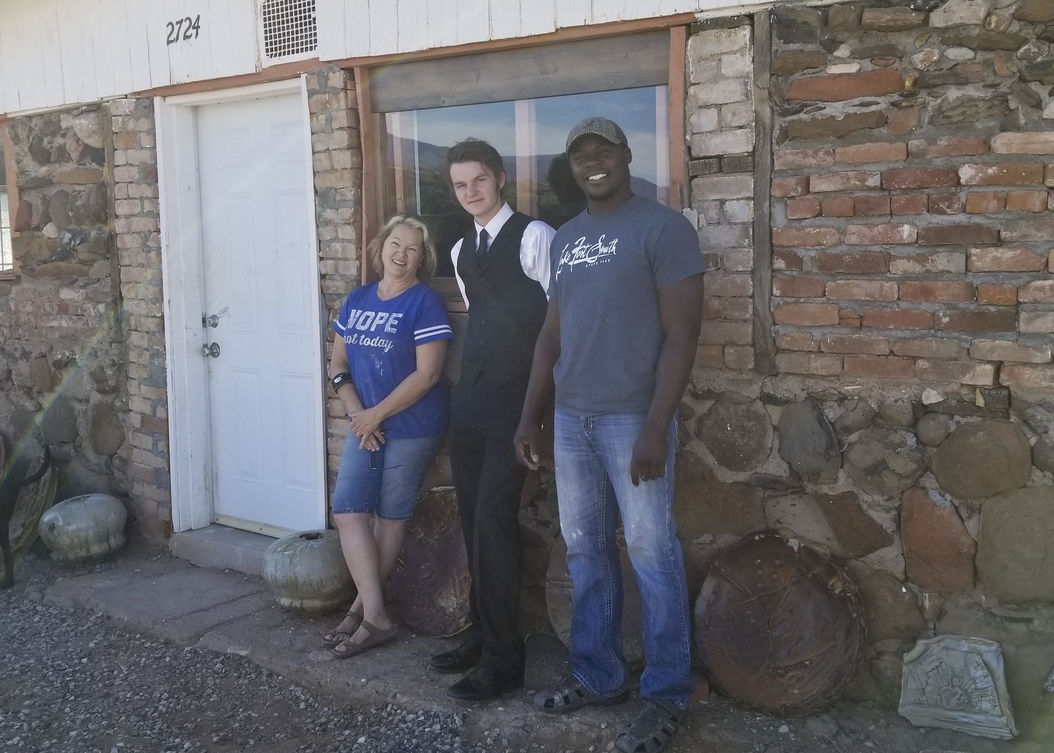 Sheryl Leigh-Davault, Ian, and Dexter Woods in front of the Reitz Ranch studio.