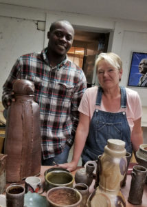Dexter Woods and Sheryl Leigh-Davault. The large piece on the left was made by Dexter and wood-fired.
